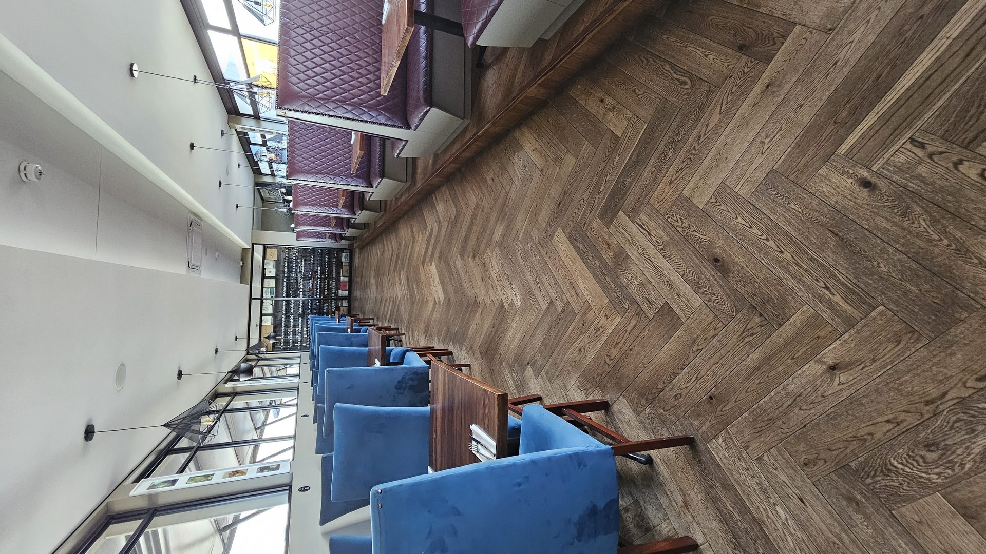 Blue velvet chairs and herringbone floor