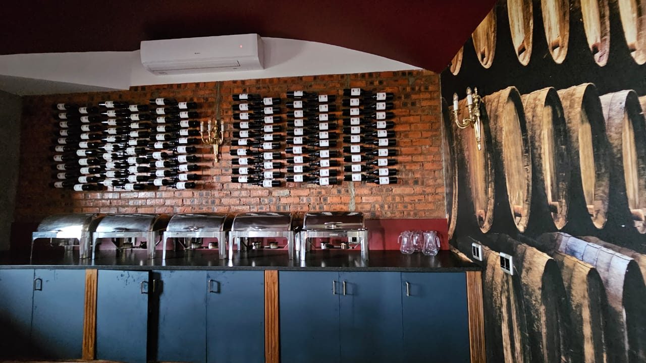 Private wine cellar with brick wall, wine display and barrel mural